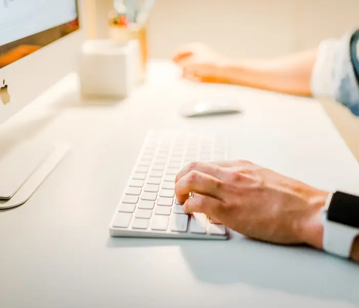 employee using computer with wireless keyboard